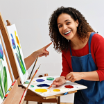 **

A person happily teaching a painting class in a bright, modern Parisian art studio. Students are diverse in age and background, all engaged in their art projects. The teacher is pointing to a student's work with a smile. Emphasis on the joy of teaching and the vibrant atmosphere. "French art class, happy teacher, diverse students, bright studio, painting lesson"

**